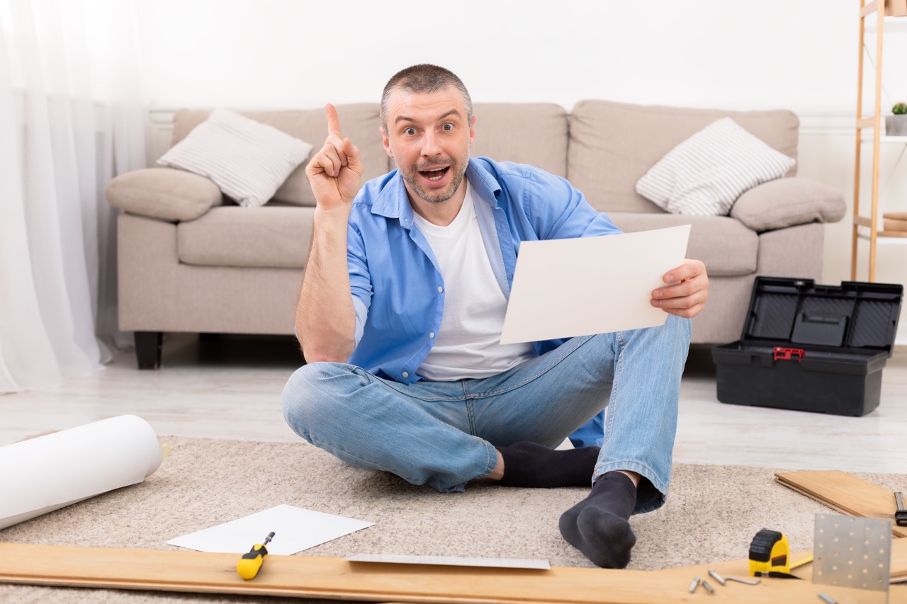 Excited,Man,Assembling,Furniture,Pointing,Finger,Up,Having,Idea,Sitting